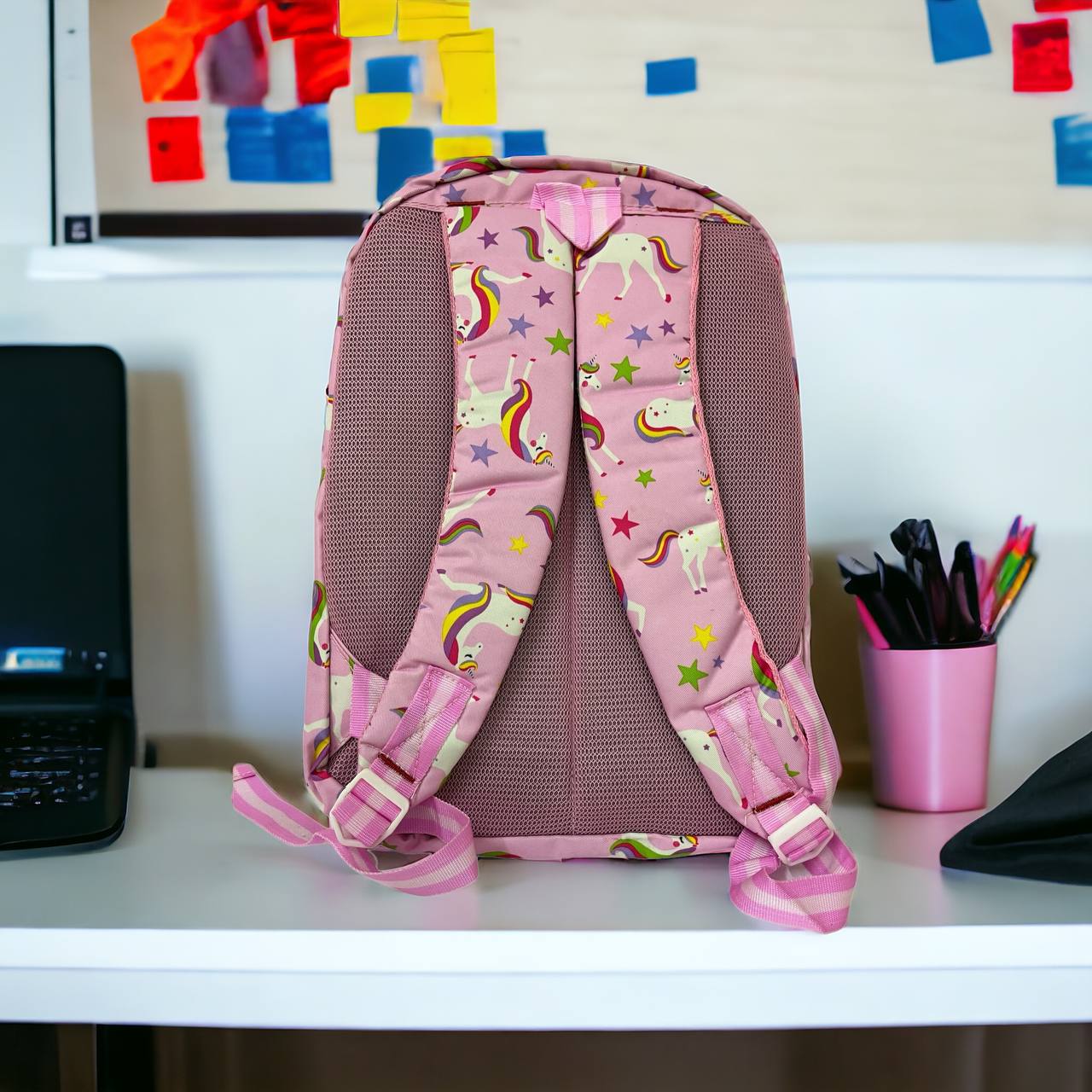 unicorn bag on top of the computer table